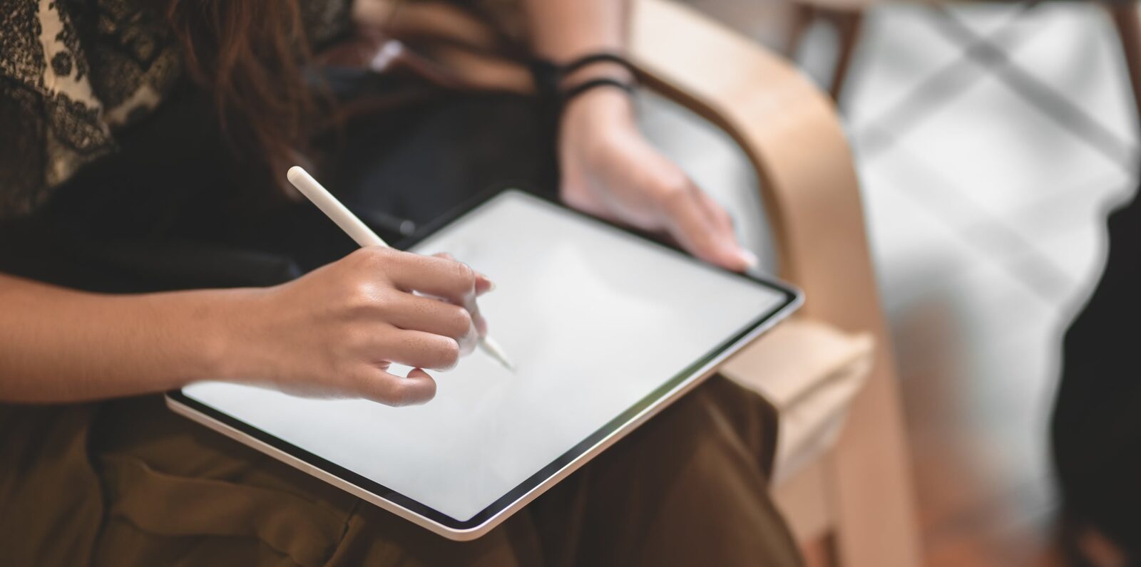 Graphic designer sketching brand concepts on a tablet