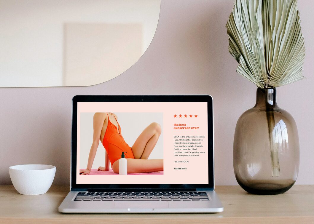 Custom website design mockup displayed on a laptop in a styled workspace